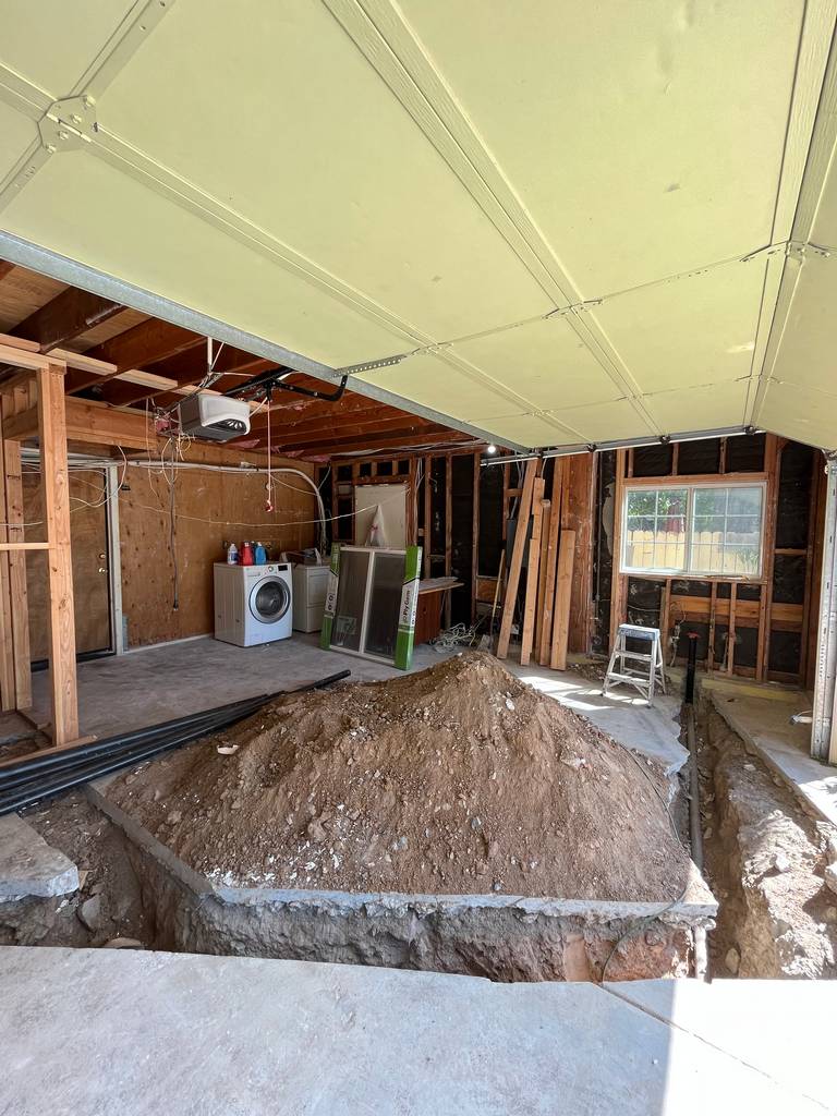 dirt removed for new plumbing and drainage lines for garage conversion