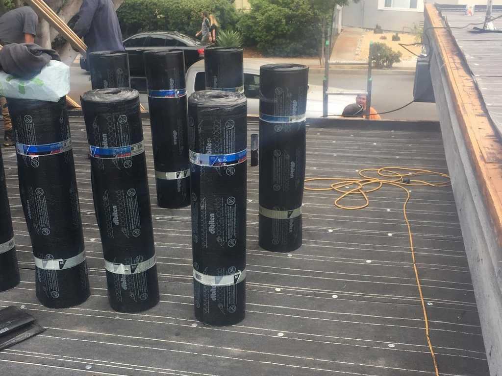 a2m contractors stack rolls of roofing paper