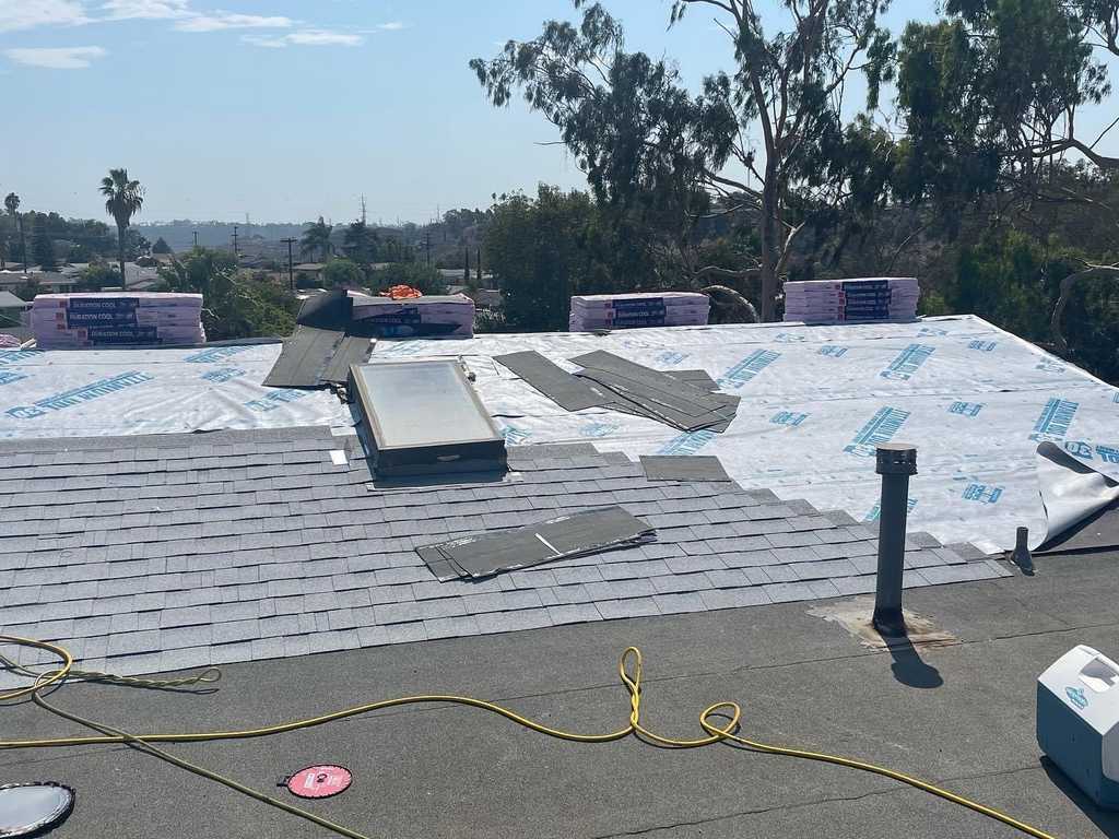 a2m contractors laying down underlayment and shingles