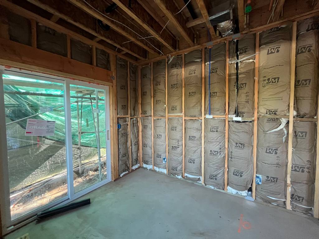 Batt insulation around framed wall with sliding glass door opening