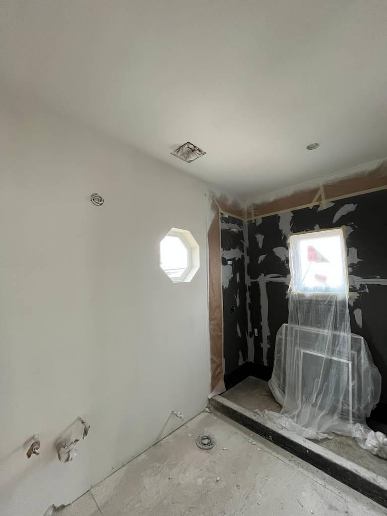 Framed shower area with waterproofing and wall prep during remodel.