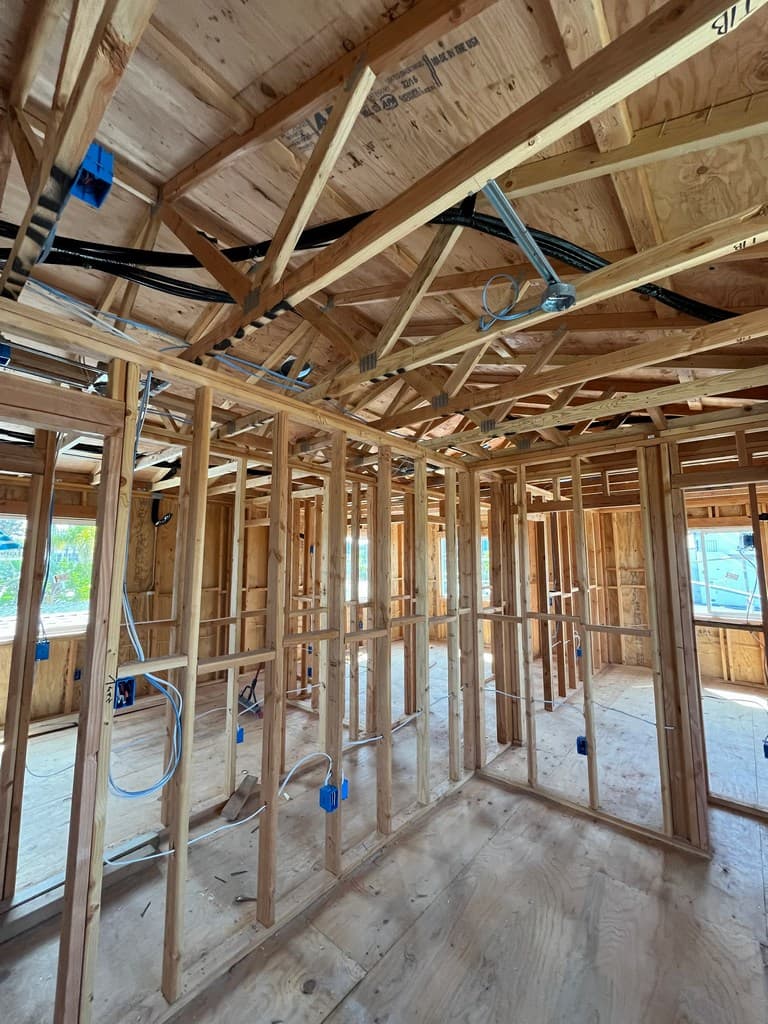 Open ADU room framing with electrical boxes.