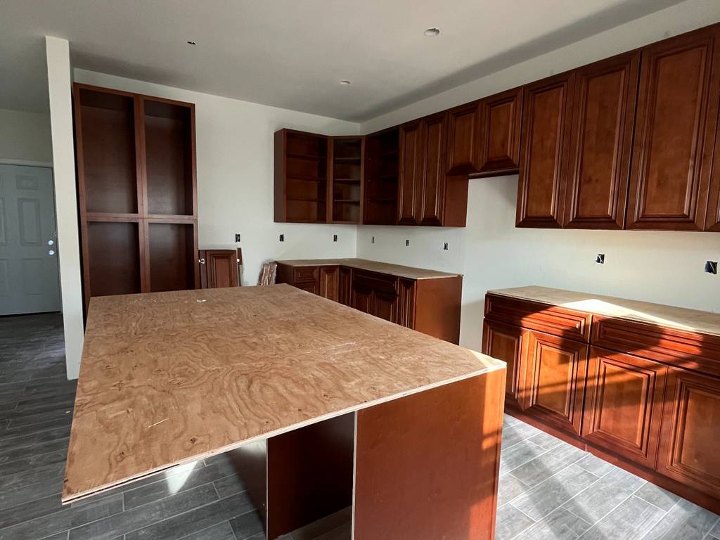 Kitchen island structure and cabinetry installed, ready for countertop.