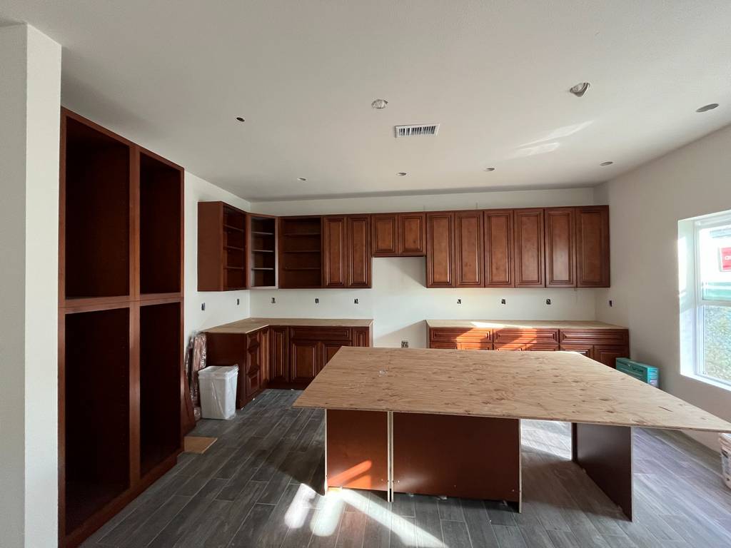 Full view of kitchen cabinetry layout and island framing.