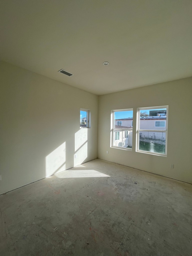 Finished interior room with painted walls and installed windows.