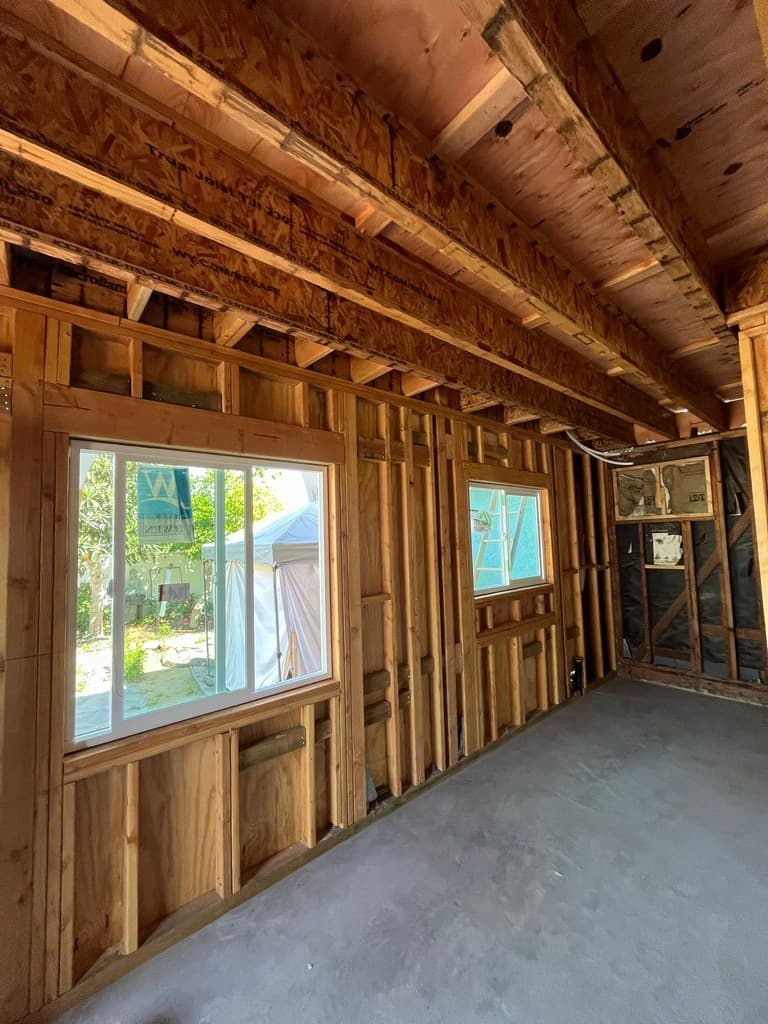 Vinyl windows installed along framed wall.