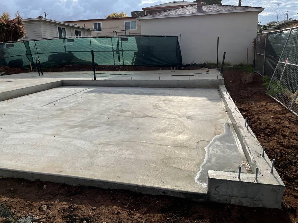 Structural concrete base set for residential framing, including stubs and trenches.