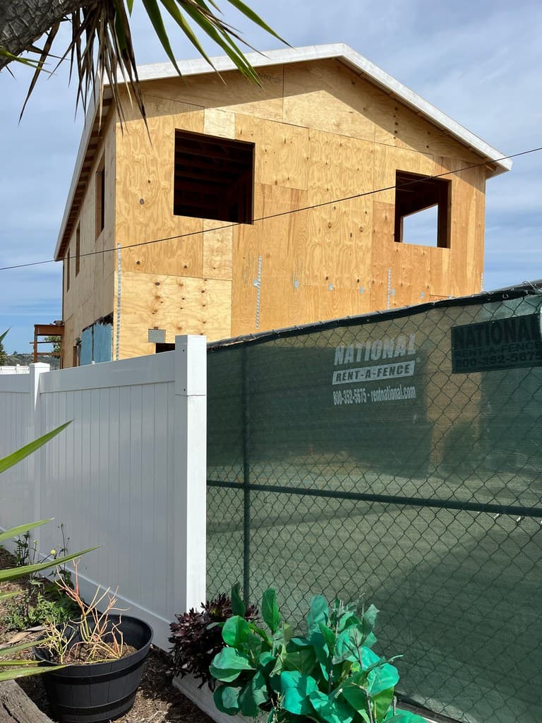 Side ADU sheathing with window openings.