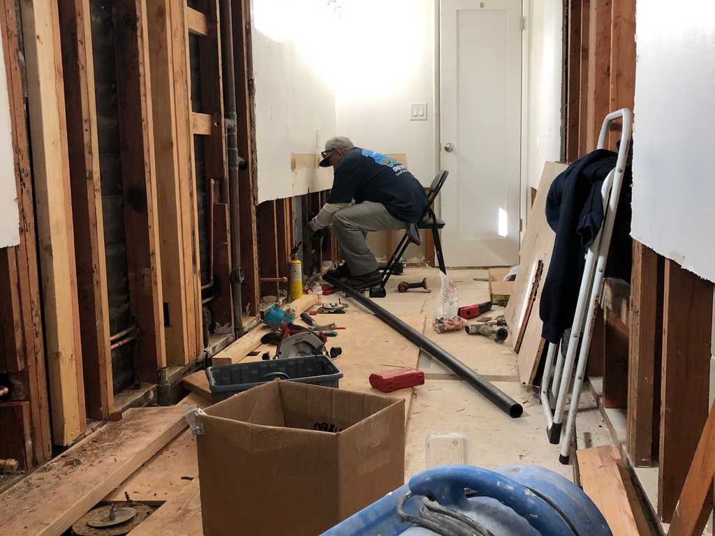 a2mContractors exposing the plumbing lines on a bathroom remodel