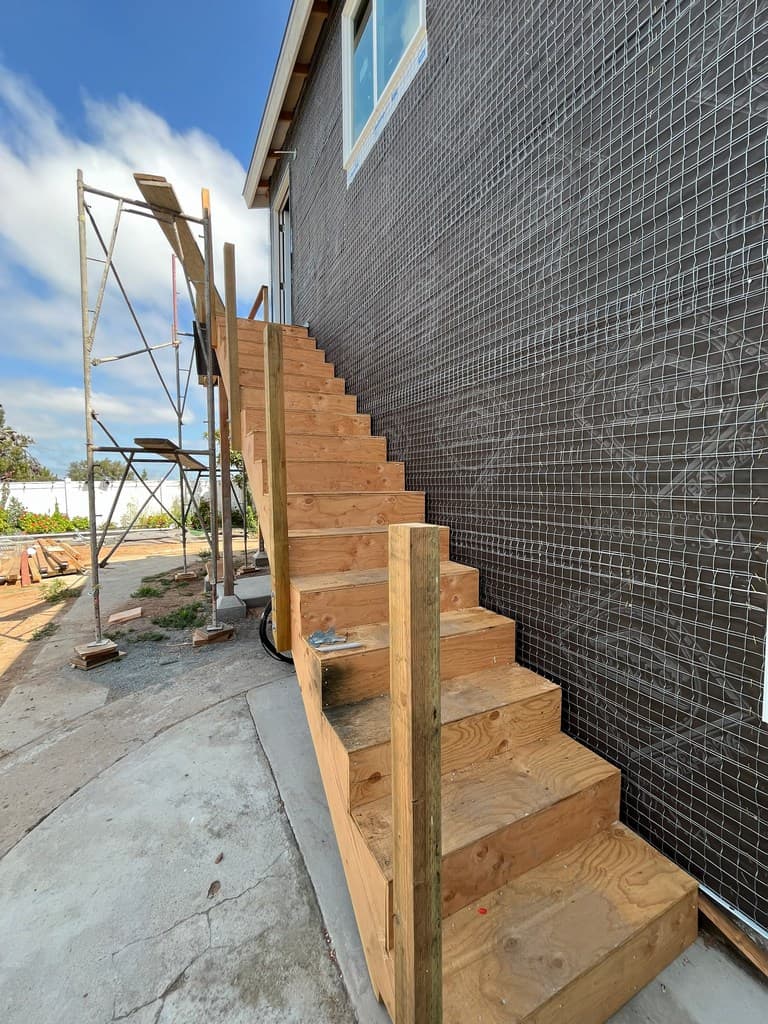 ADU stairway framing beside exterior lath.