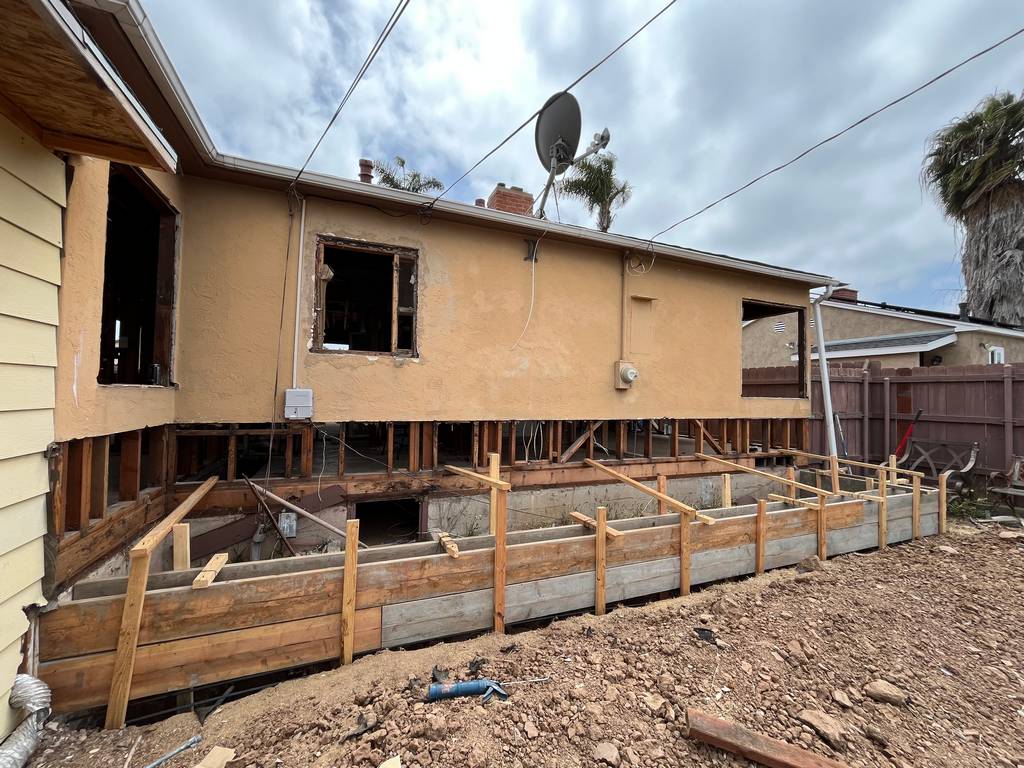 Rear elevation showing structural wall removed and new formwork installed for extended concrete footing under crawl space.