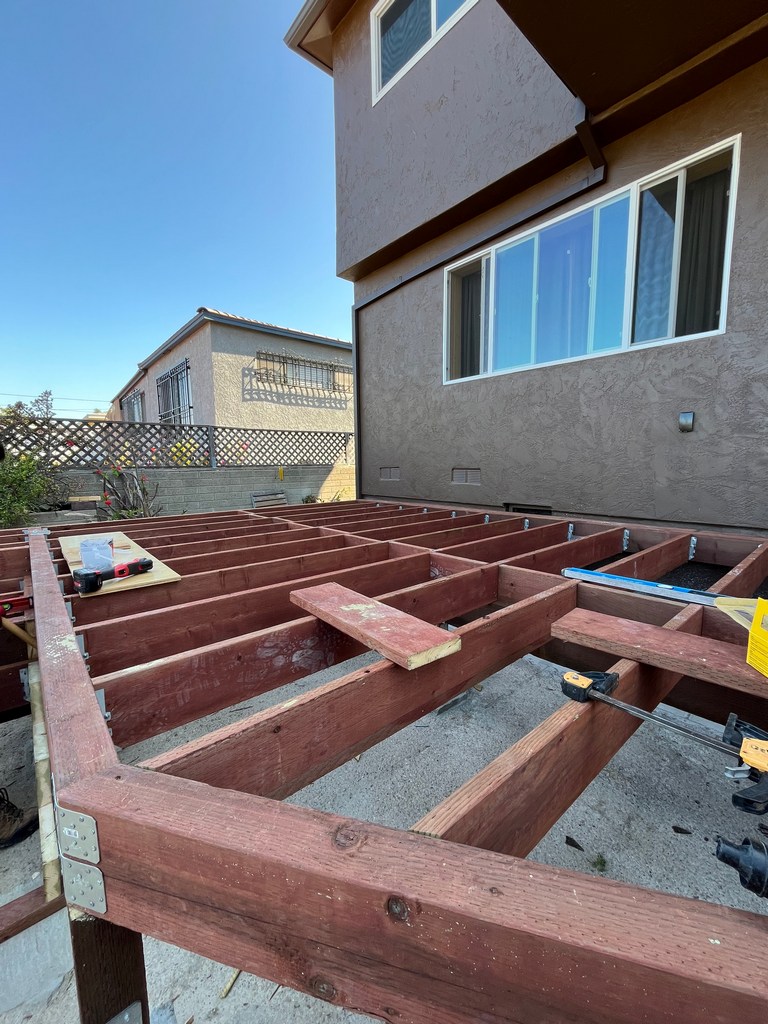 Backyard ADU deck framing with pressure-treated lumber