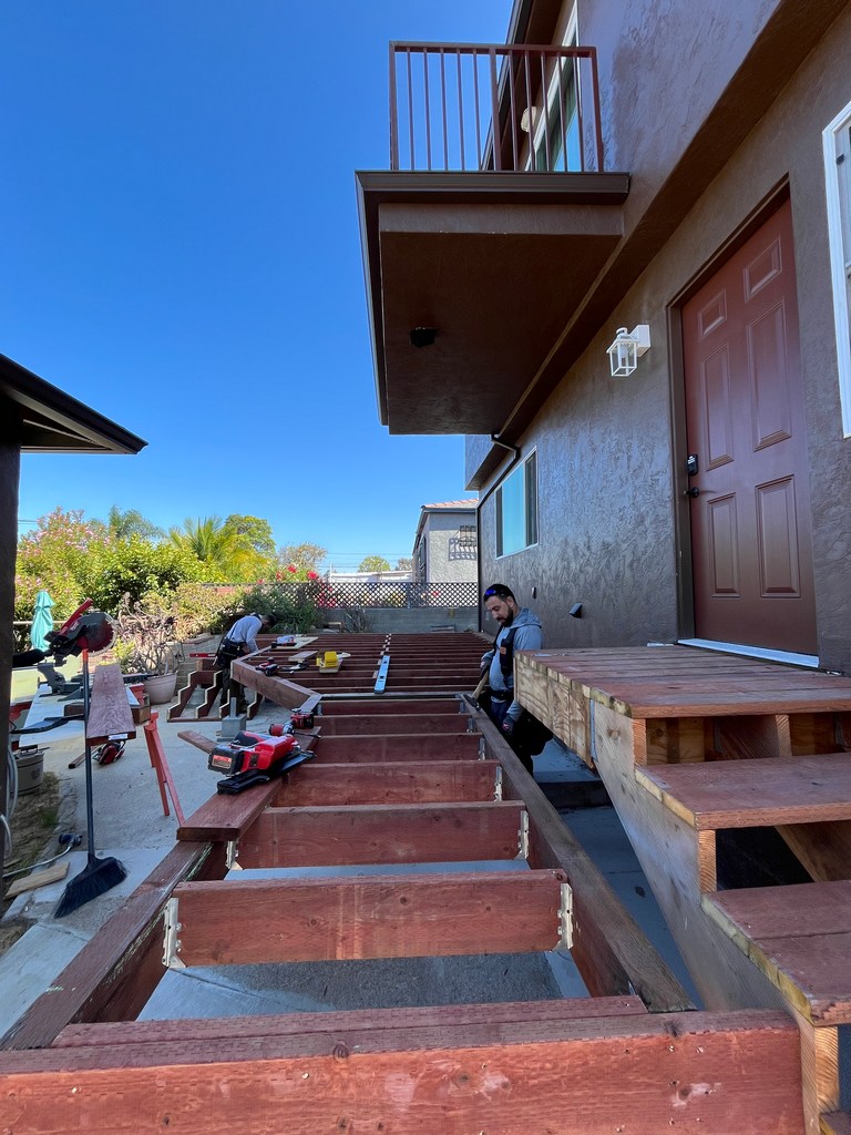 Exterior deck framing beside finished ADU