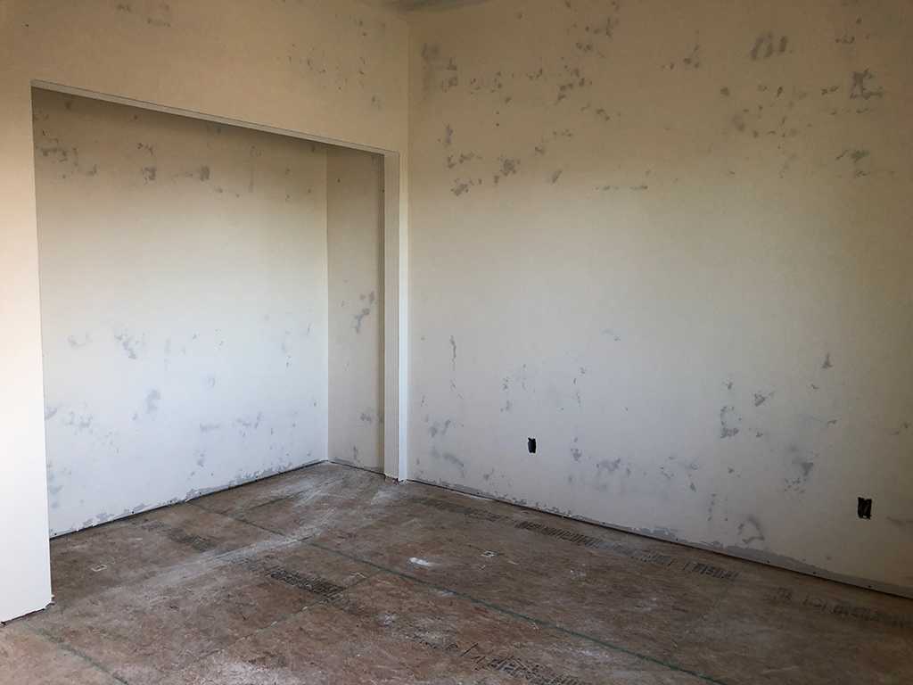 ADU bedroom with closet drywalled ready for primer