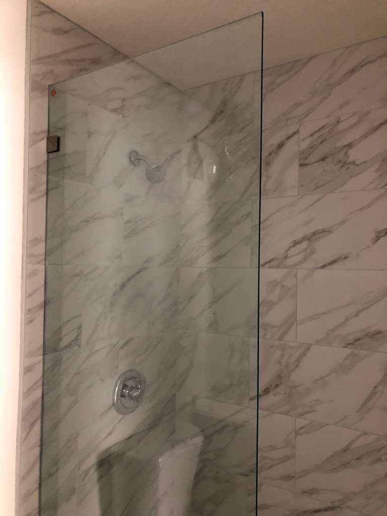 new-custom-walk-in-shower-with-stationary-glass-wall-in-front-unit-remodel