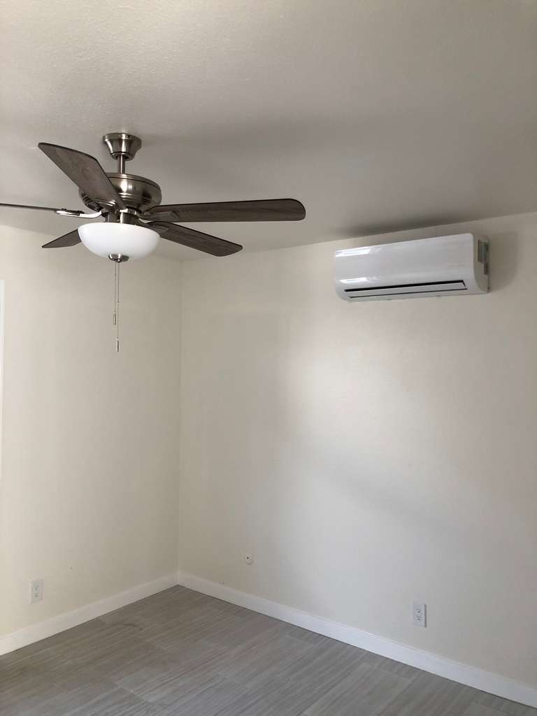 ADU-showing-5-blade-ceiling-fan-and-wall-attached-ac-in-the-new-bedroom