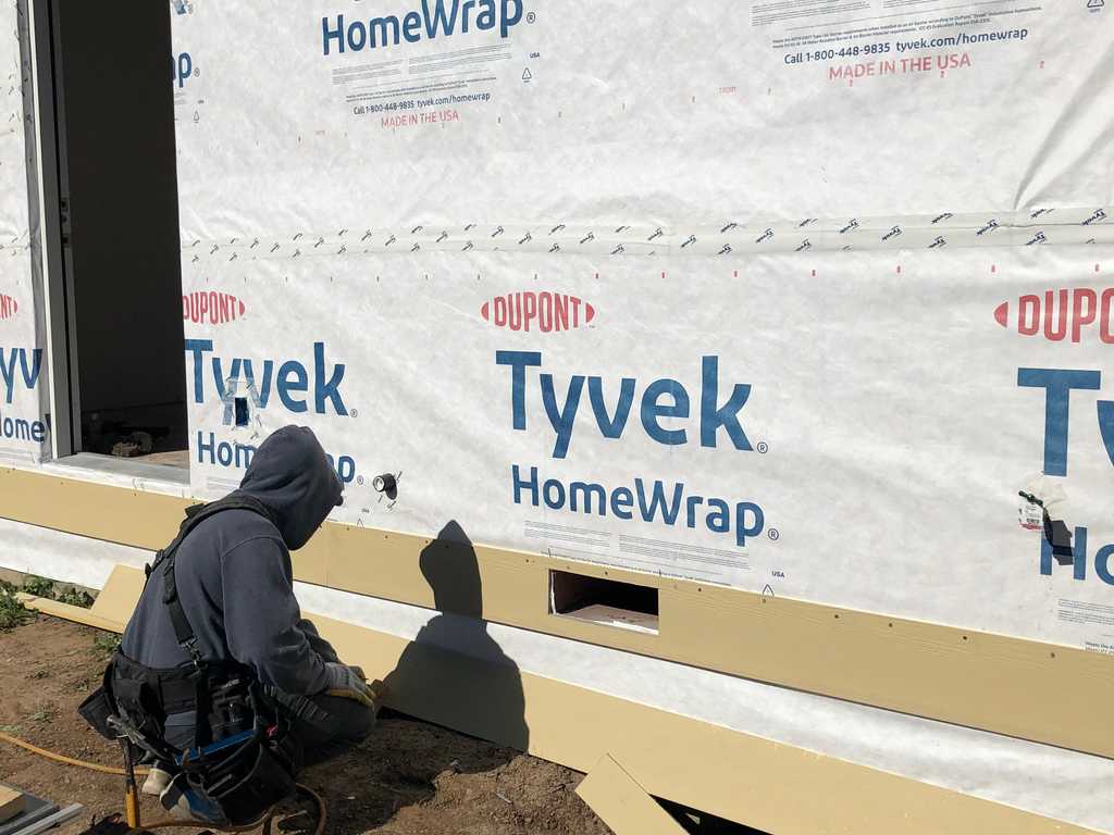 attaching plywood around the perimeter of Tyvek HomeWrap