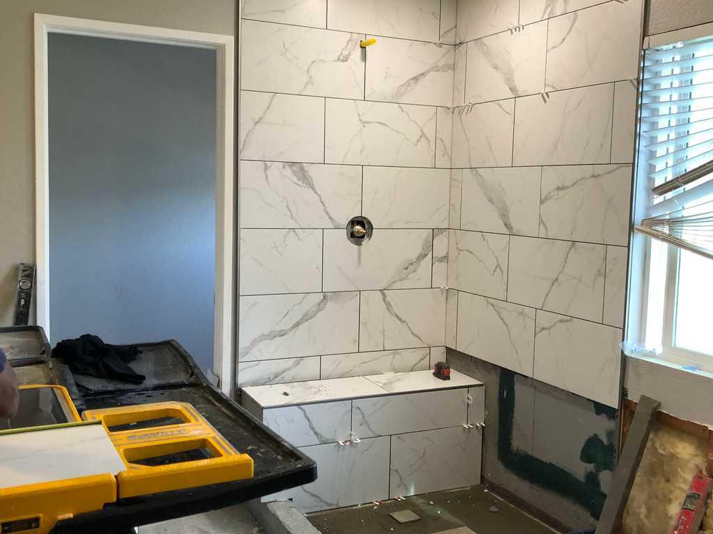 bathroom remodel beginning to set the marble tile