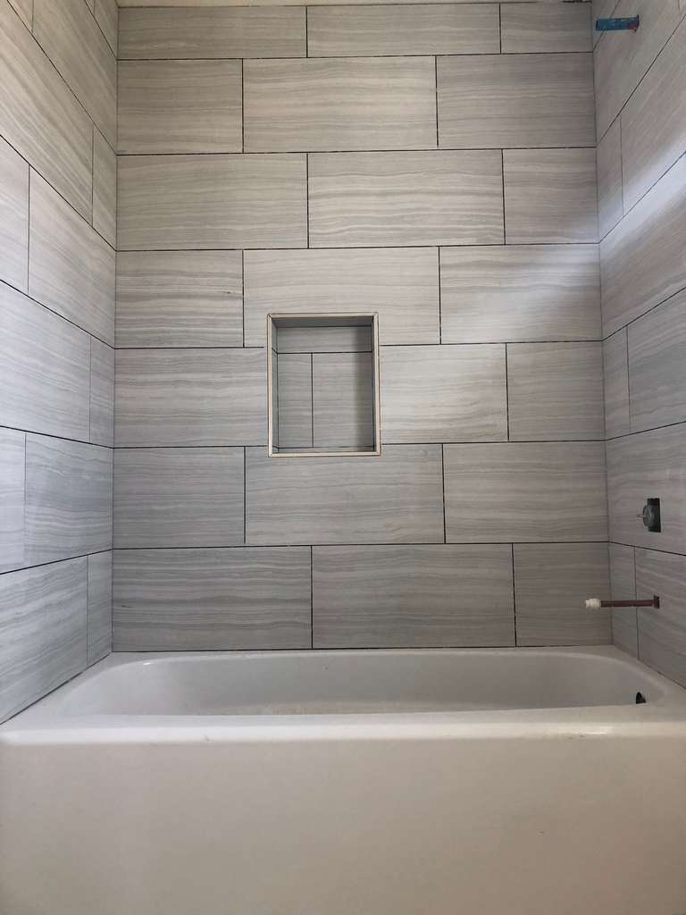 ADU-showing-new-single-tub-and-marble-tile-panel-work