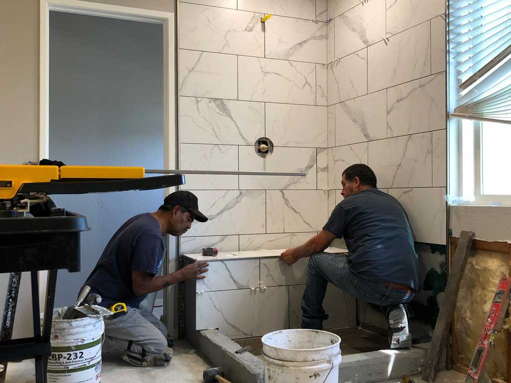 bathroom remodel A2M Contractors setting shower tiles