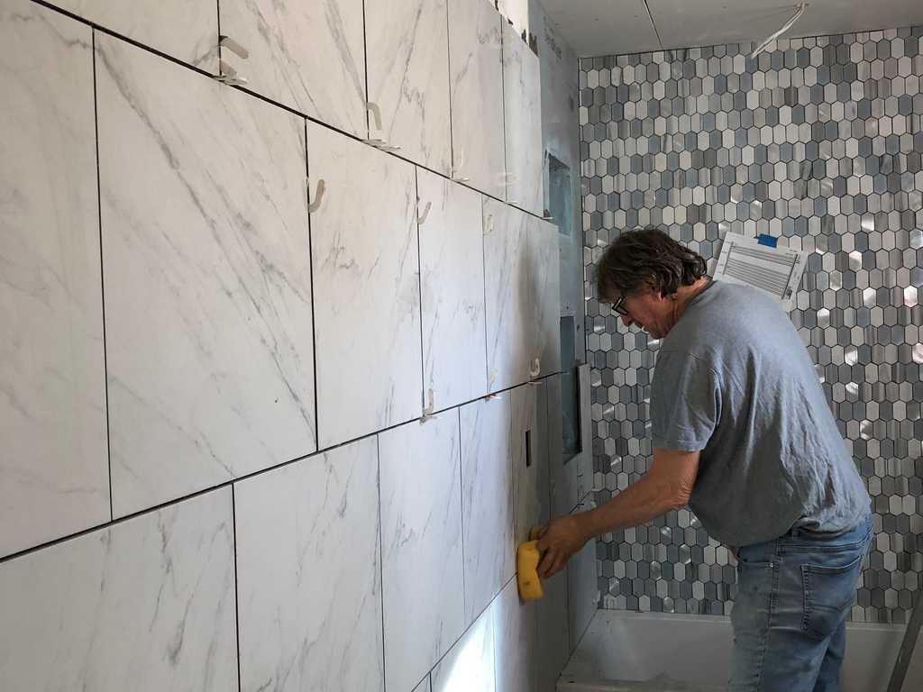 professional tile worker grouting marble tile