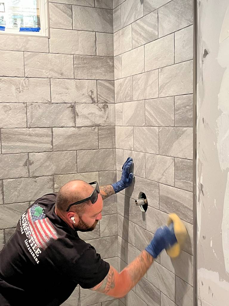 Precision grout application by a skilled tile artisan.