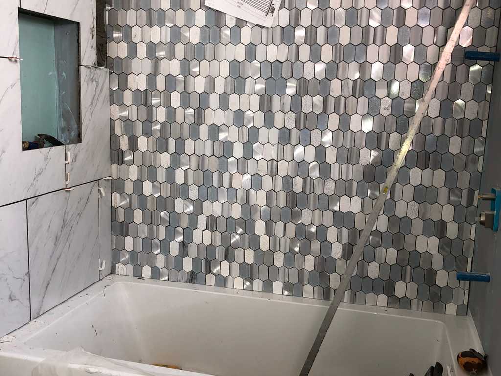 mosaic tile wall above the bathroom tub