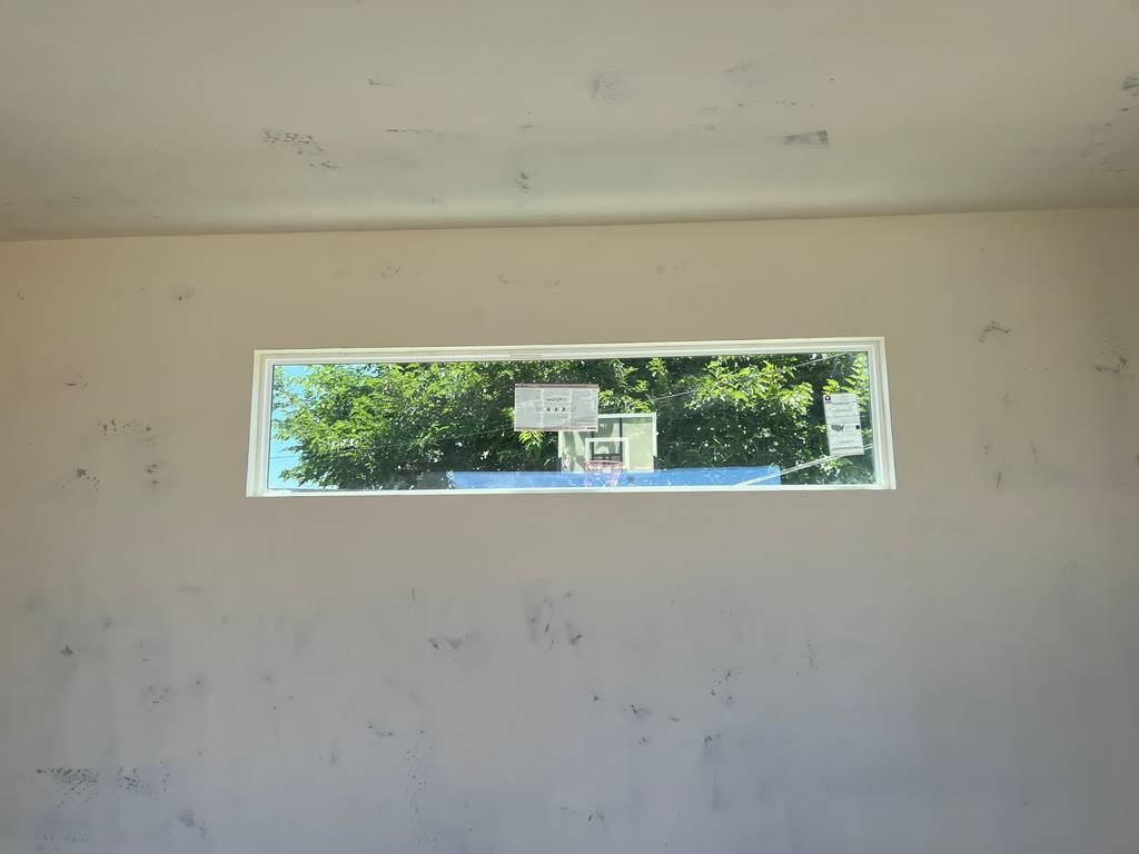 drywall mud applied around a stationary window