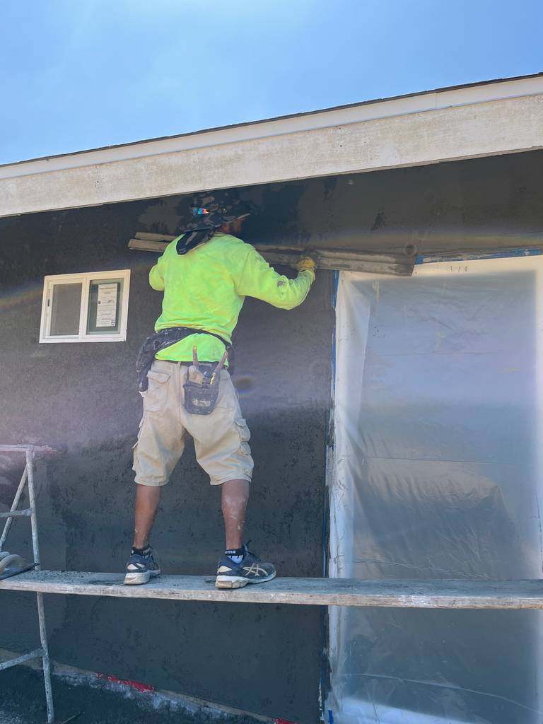 Craftsmen Applying Stucco with Expertise