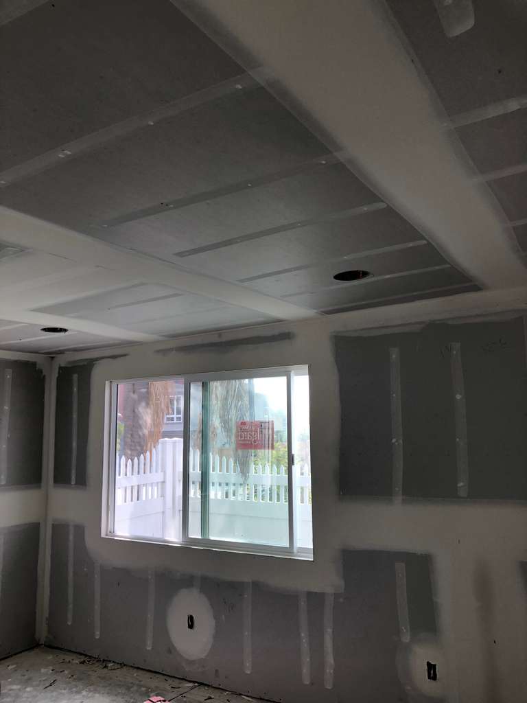 drywall-compound-applied-bedroom-wall-and-ceiling