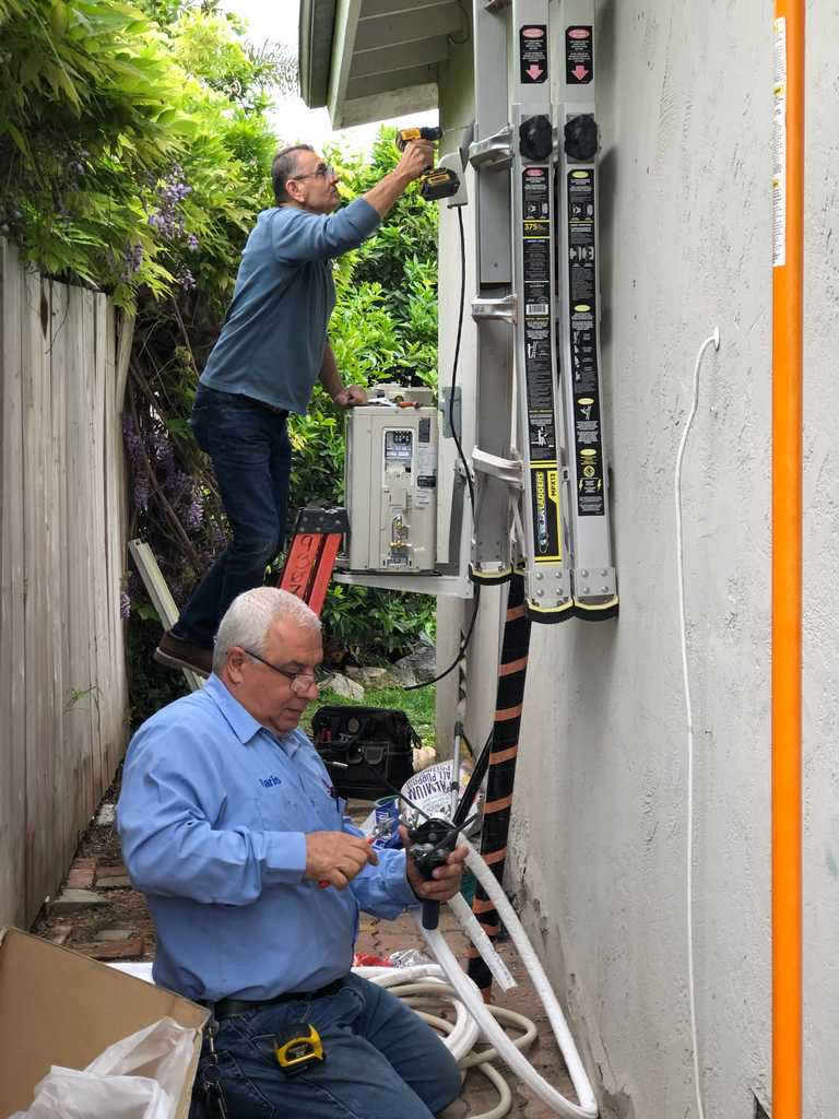 garage conversion HAVC workers connecting new system