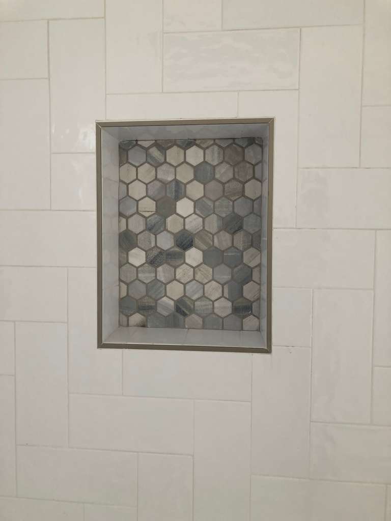 new shower with mosacic tile shelf