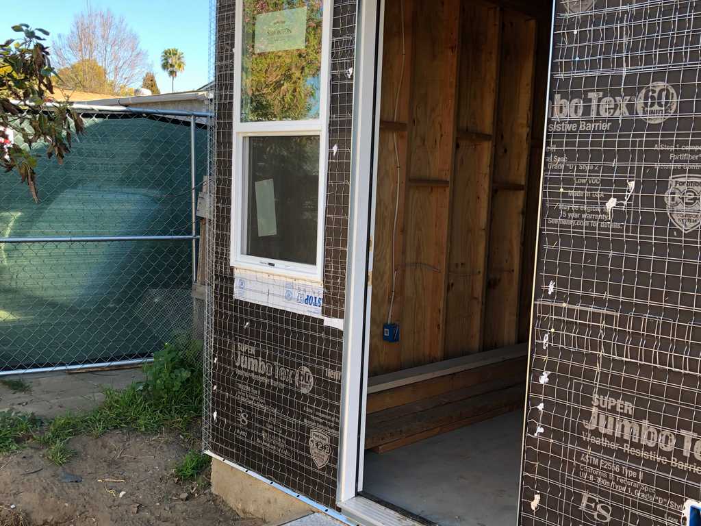 ADU showing concrete step stucco paper and vinyl windows