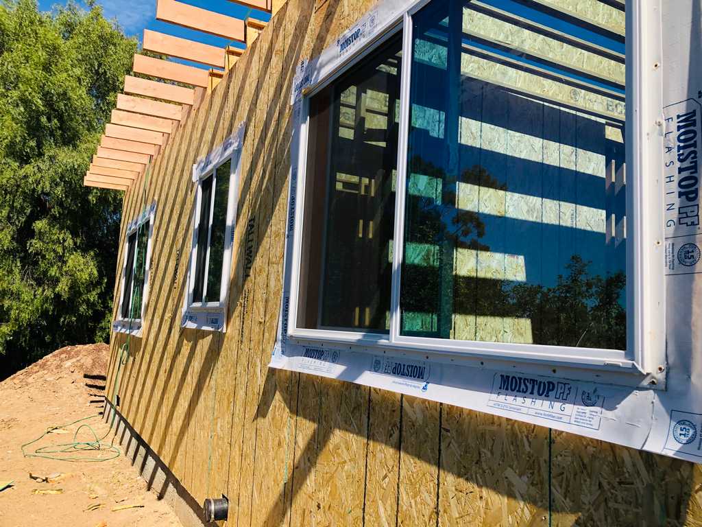 ADU exterior wood sheathing wiht new vinyl windows