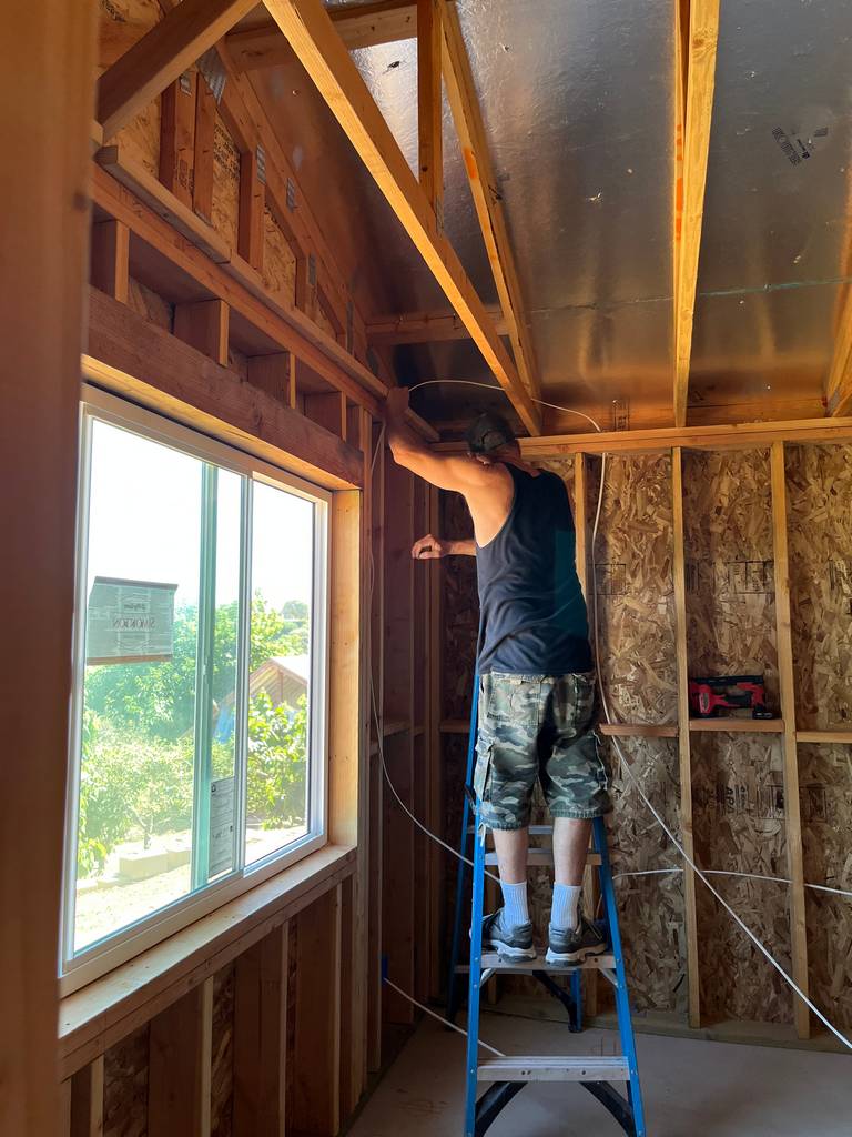 electrician running romex wire