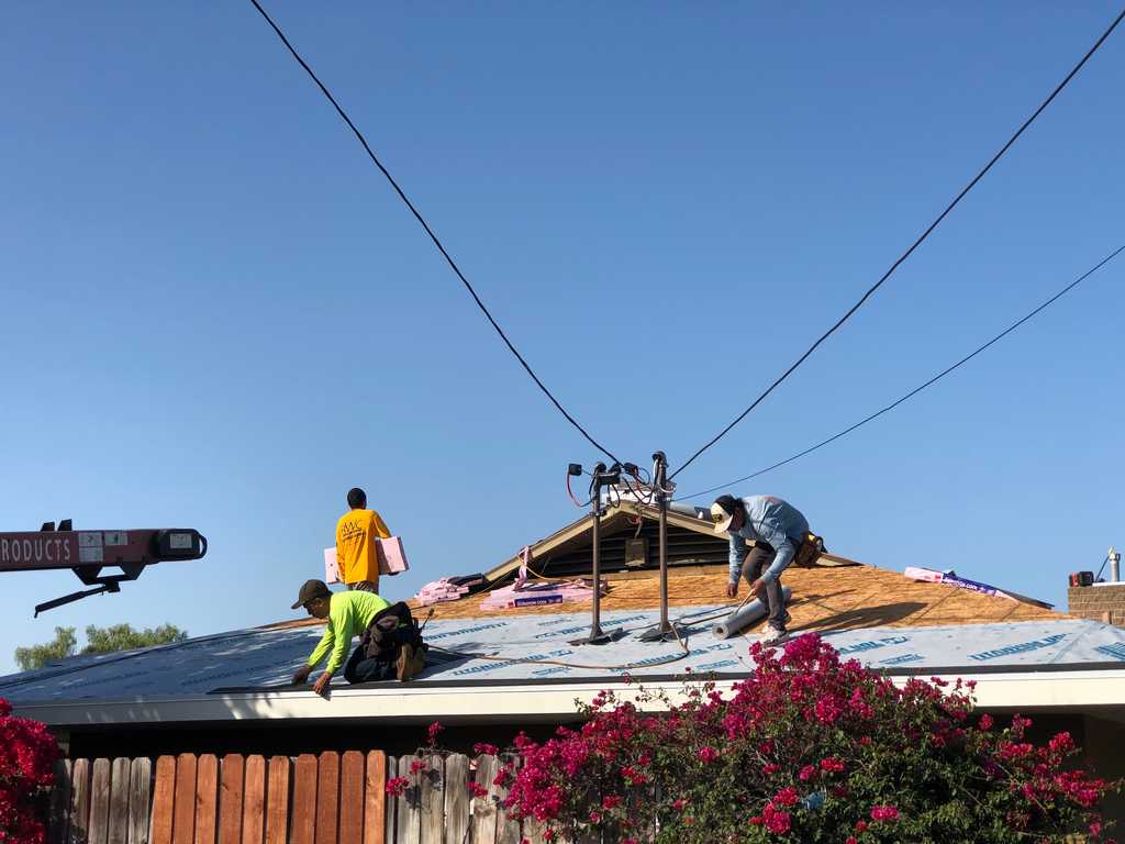 Roofing Contractors attaching roofing underlayment