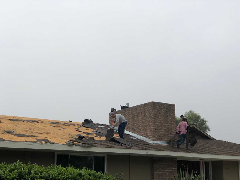 a2mContractors showing old roof shingles getting ready for new roof